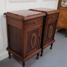 Pair of French Art Deco Oak and rouge inset marble top bedside cabinets. They have one drawer and one cupboard with elegant carving on the door. They have been sourced from France and are in good original detailed condition.