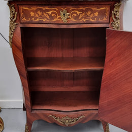 Stunning French Transitional style Mahogany marquetry inlay salon cabinet in the bombe shape. It has one draw, one shelf, marble top & ormolu decoration. Sourced from France and in good original detailed condition.