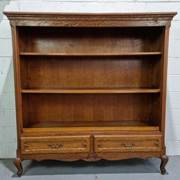 Lovely French Oak Louis XV style open shelf bookcase with two drawers for storage and three shelves in good original detailed condition.