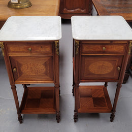 Pair of white marble topped Louis 16th style bedside cabinets consisting of one drawer and one cupboard.  Inlaid with burr walnut and has decorative mounts. They have been sourced from France and are in good original condition.