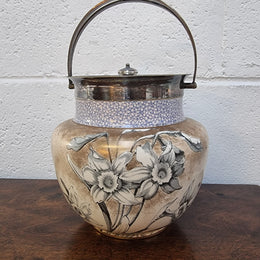 Royal Doulton Biscuit Barrel with silver plated top, handle and lid. Displaying a Daffodil pattern. In original condition please view photo's as they form part of the description.