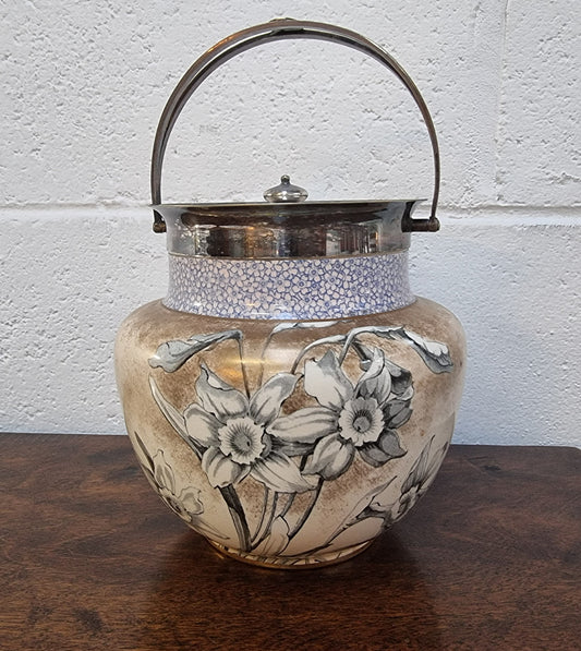 Royal Doulton Biscuit Barrel with silver plated top, handle and lid. Displaying a Daffodil pattern. In original condition please view photo's as they form part of the description.