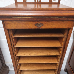 Antique Edwardian roll top Tambour file cabinet desk. This practical antique tambour front filing cabinet dates around 1900 in the Edwardian period and is constructed from Oak. This antique cabinet has an adjustable writing slope, above a tambour front with key and working lock. It has been sourced locally and is in good original detailed condition.