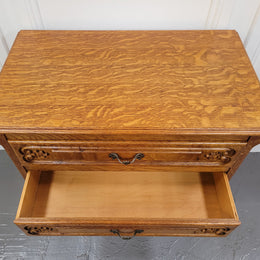 Vintage French light Oak Louis XV style chest of three drawers. It has beautiful cabriole legs, elegant brass handles and carvings. It is in good original detailed condition and has been sourced from France.