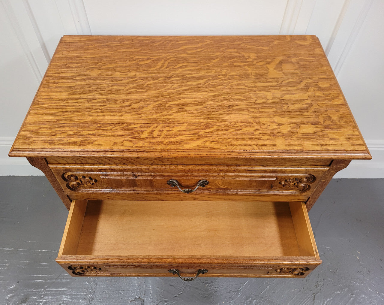 Vintage French light Oak Louis XV style chest of three drawers. It has beautiful cabriole legs, elegant brass handles and carvings. It is in good original detailed condition and has been sourced from France.