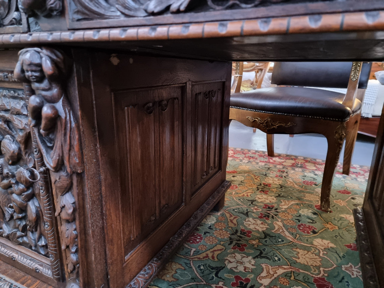 Beautifully carved French Oak early 19th century pedestal desk with 3 drawers, two cupboards and a secret cupboard on the side. There is also a lovely burgundy tooled leather top. In good original detailed condition.