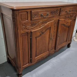French Walnut two door buffet with parquetry top. It has two drawers and an adjustable shelf. In good original detailed condition and it has been sourced from France.