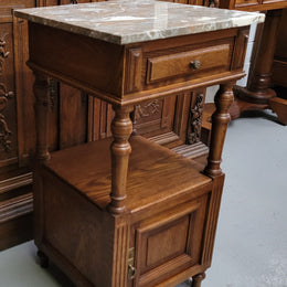 Pair of French Antique Oak marble top bedsides Henry II style. They have a drawer, cupboard and an open shelf for all your storage needs. They have been sourced from France and are in good original detailed condition.
