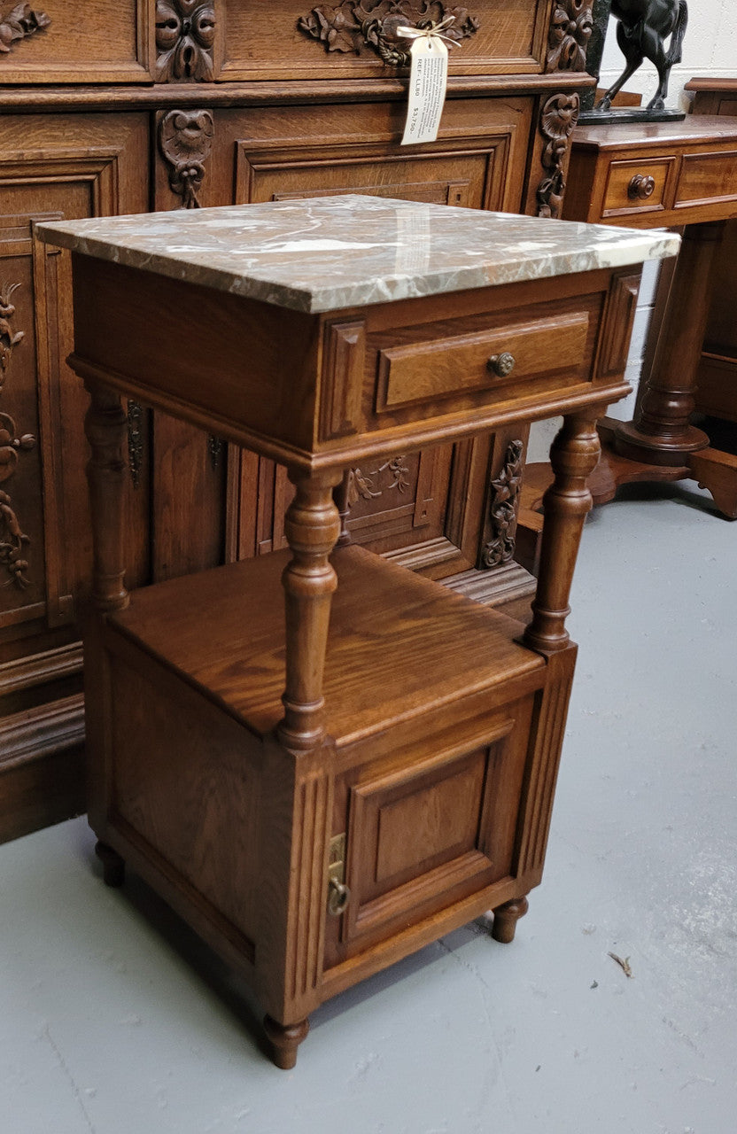 Pair of French Antique Oak marble top bedsides Henry II style. They have a drawer, cupboard and an open shelf for all your storage needs. They have been sourced from France and are in good original detailed condition.