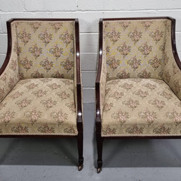 Pair of Regency style wing back armchairs with original castors and tapestry upholstery. They are in good original detailed condition.