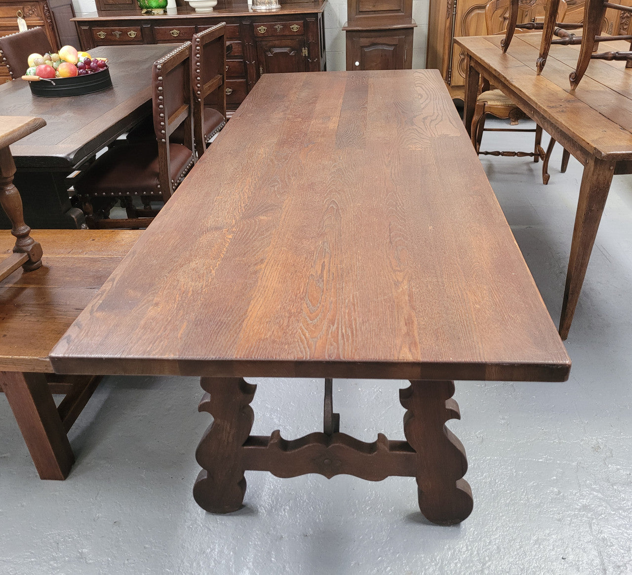 Spanish style French Oak farmhouse table with ironwork underneath. It is in good original detailed condition and has been sourced from France.
