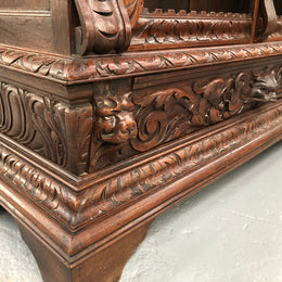 Amazing dark Oak heavily carved Gothic style bookcase with lovely details and adjustable shelves in good original detailed condition. The doors currently have no glass which can easily be added or be left  with open shelves.