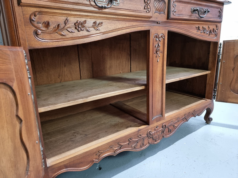 Stunning 19th Century French Walnut Buffet à Glissant from Provence, France. This is an exceptional charming piece and very functional with plenty of storage space, two large cupboards at the bottom, two drawers in the middle and two sliding doors either side at the top and finished off with a small central cupboard. In good original detailed condition.