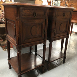 Lovely pair of French Oak Louis XVI style bedside cabinets with inset marble tops a drawer and a cupboard for storage. In good original detailed condition.