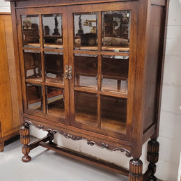 Tudor oak 2 door astral glaze and beveled glass bookcase.  Good original condition. Circa 1930s.