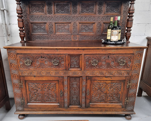 Impressively carved 18th Century English Oak kitchen dresser in 17th Century Jacobean style. It is in good original detailed condition and has been sourced from France.