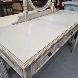 French Louis XVI style painted dresser / console with beveled oval mirror and three drawers. Sourced from France and in good original detailed condition.