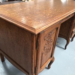 Beautifully carved French oak small desk with three drawers and a cupboard for all your storage needs. In good original condition. Great size for small spaces.