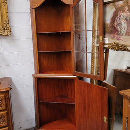 Practical Walnut corner cabinet with display and storage. Two shelf glass display on top and single shelf cupboard below. Sourced locally and in good original detailed condition.