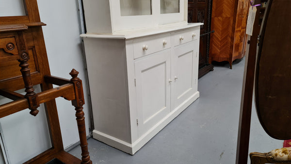 Australian painted two door kitchen hutch display and buffet cabinet. The top section has hooks and shelves. The bottom has two drawers along with cupboard space for added storage. In good original condition.