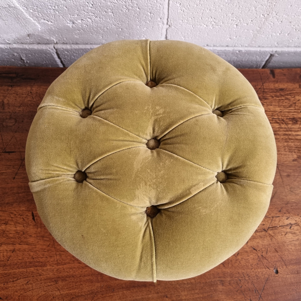 Vintage round upholstered buttoned footstool. Sourced locally and is in good original condition, please view photos as they help for part of the description.