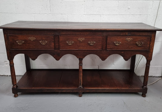 Antique 19th Century English dark Oak three drawer Dresser with brass handles and in good original condition.