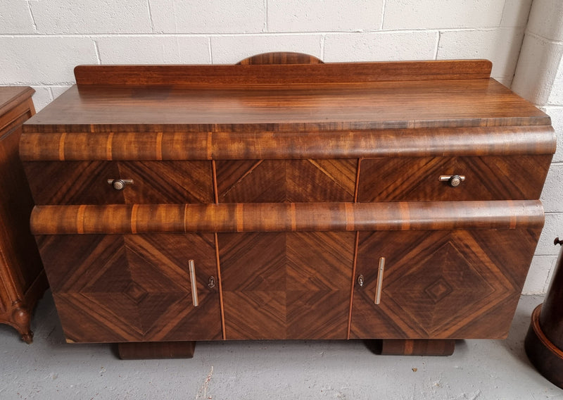 Vintage Walnut Art Deco “Waterfall” sideboard buffet with two drawers and two doors. It is in good original condition and has been sourced locally.