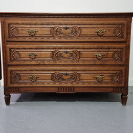 Early 19th Century French Oak chest of three drawers. It has beautiful handles and carvings. It is in good original detailed condition.