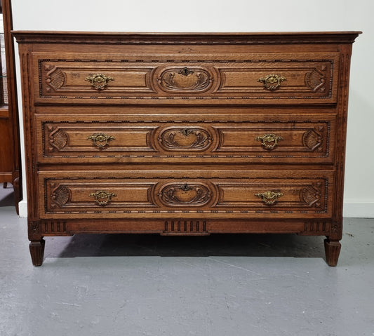 Early 19th Century French Oak chest of three drawers. It has beautiful handles and carvings. It is in good original detailed condition.