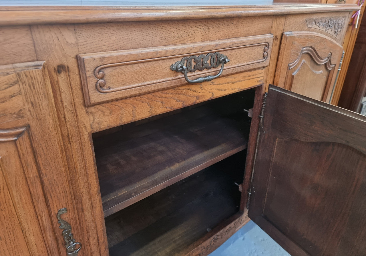 Lovely French Oak three-door sideboard with beautifully carved details and there is also a drawer. In good original detailed condition.