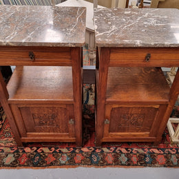 Charming pair of French Oak Arts and Crafts bedsides with shelf, cupboard with carving and marble top.  They have been sourced from France and are in good original detailed condition.