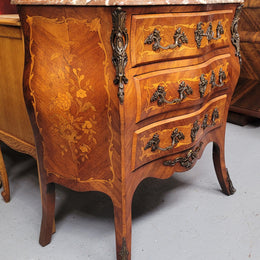 Antique French Louis XV style compact three drawer marble top commode with marquetry inlay and ormolu mounts. Sourced from France and in good original detailed condition.