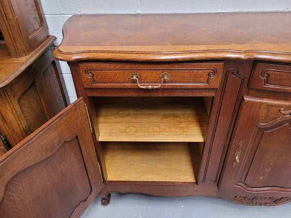 French Oak Louis XV style three drawer three door parquetry top sideboard. It has been sourced from France and is in good original detailed condition.