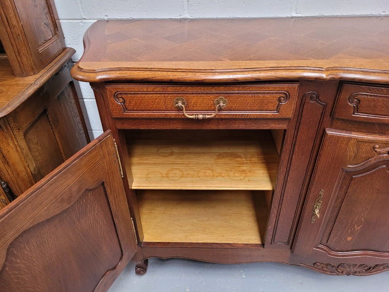 French Oak Louis XV style three drawer three door parquetry top sideboard. It has been sourced from France and is in good original detailed condition.