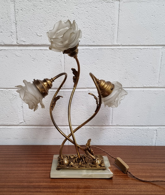 Art Deco alabaster and gilt brass table lamp with three branches and glass tulip shades. In good original detailed working condition.