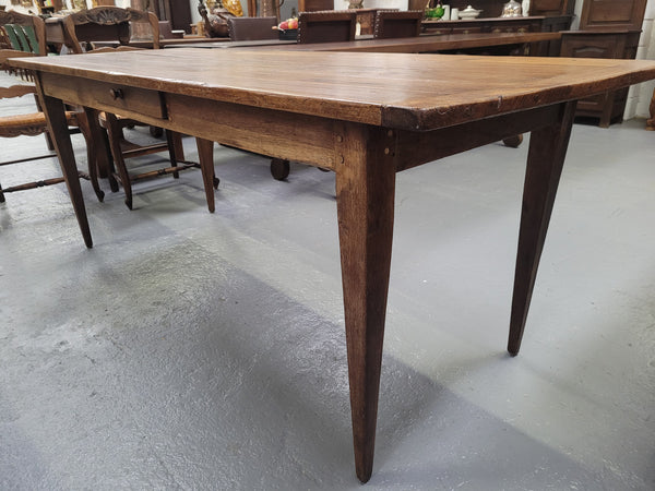 Provincial 19th Century French Oak rustic farmhouse table with tapered leg and single drawer. It has been sourced from France and is in good original detailed condition. 