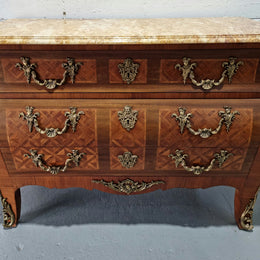 A beautifully inlaid parquetry three drawer commode with a lovely marble top, and decorative ormolu mounts. In good original detailed condition. Circa 1930