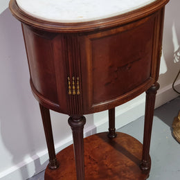 Round Louis XVI style Mahogany marble top side table. It has one drawer and a cupboard for storage. It is in good original detailed condition.