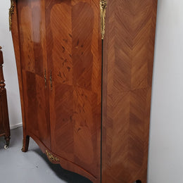 French Louis 15th style Kingwood marquetry inlaid two door cupboard with a beautiful marble top. It has three adjustable shelves and decorative ormolu trim. It has been sourced from France and is in good original detailed condition.