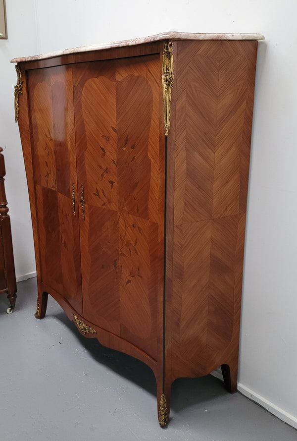 French Louis 15th style Kingwood marquetry inlaid two door cupboard with a beautiful marble top. It has three adjustable shelves and decorative ormolu trim. It has been sourced from France and is in good original detailed condition.
