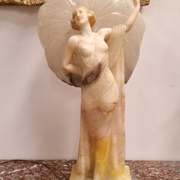 Monumental Art Deco alabaster and marble figural lamp modelled as a seductively dressed semi naked woman. In subtlety coloured diaphanous robes with a large clam shell light backdrop. Italian circa 1920's signed to base. This is a world class example of a true Art Deco sculpture lamp. It is in good original detailed condition, please view photos as they help form part of the description.