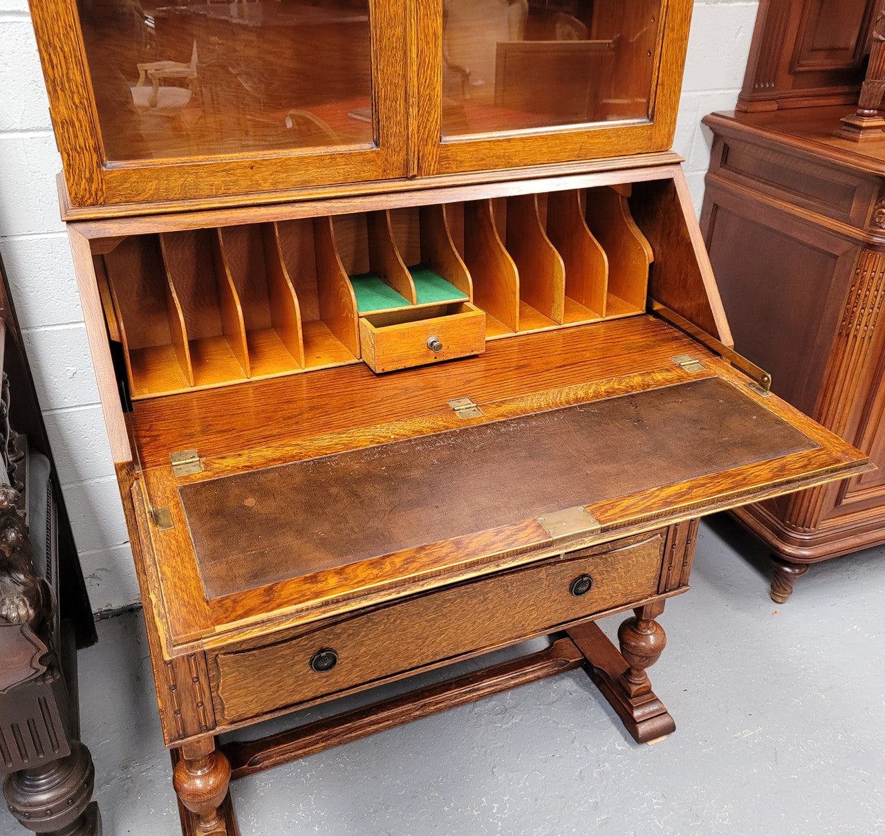 Stunning Art Deco secretary desk bookcase with heaps of storage space. It has a leathered writing area, bookcase with three adjustable shelves and three large drawers at the bottom. It has been sourced locally and in good original detailed condition.