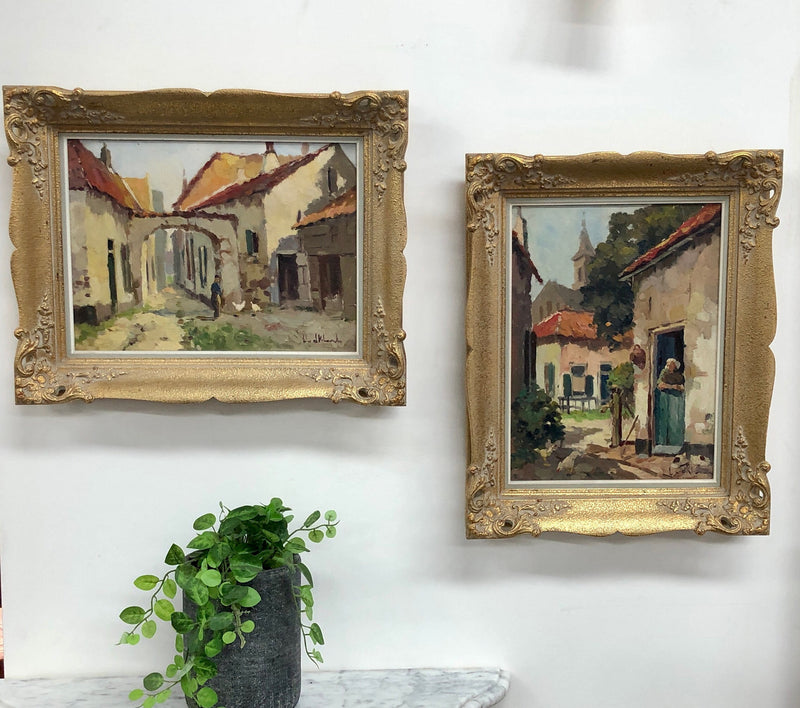 Pair of Vintage framed French oil on canvas of "Village Scenes". They are both in good original detailed condition.