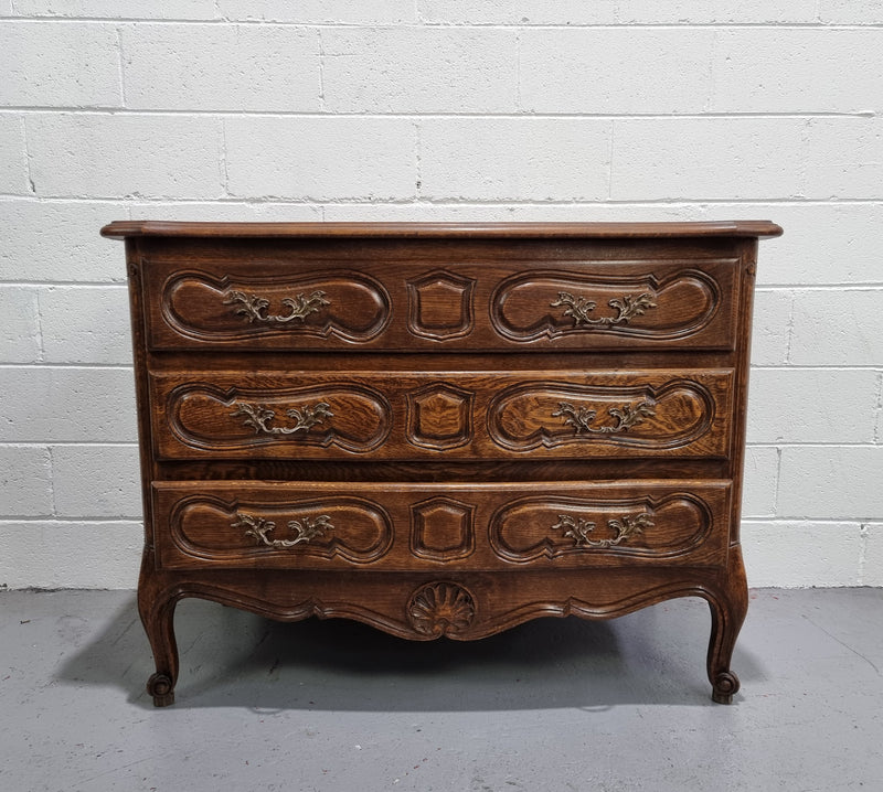 Lovely French nicely carved chest of 3 drawers with a parquetry top, with decorative handles and lovely carving. In good detailed condition.