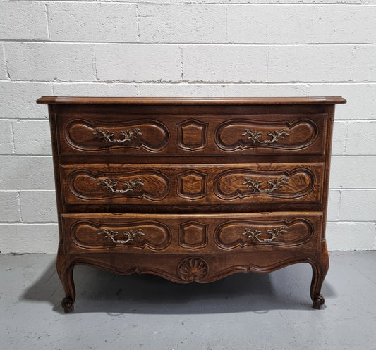 Lovely French nicely carved chest of 3 drawers with a parquetry top, with decorative handles and lovely carving. In good detailed condition.
