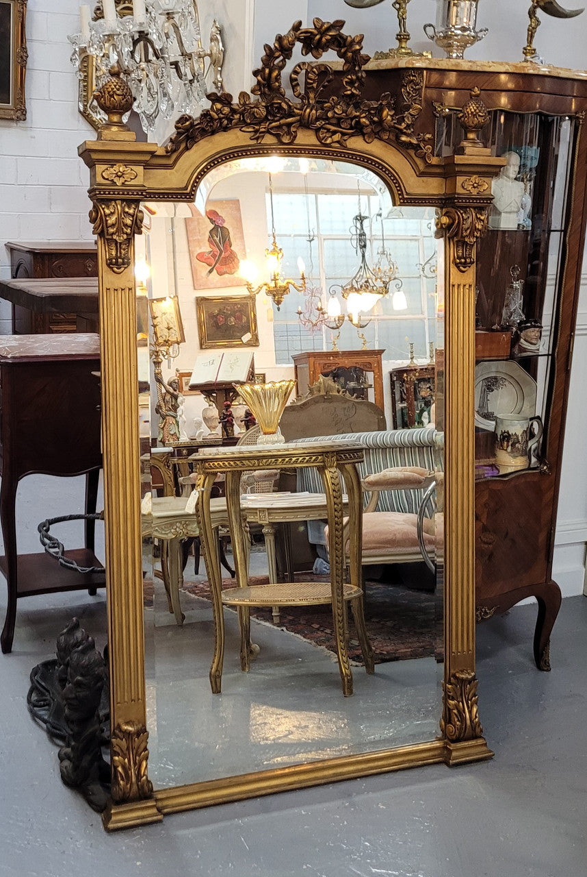 French Louis XVI style Napoleon III (1870’s) gilt mantle mirror. Beautifully carved and decorated with original bevelled mirror showing signs of age. It is in good original detailed condition and has been sourced from France.