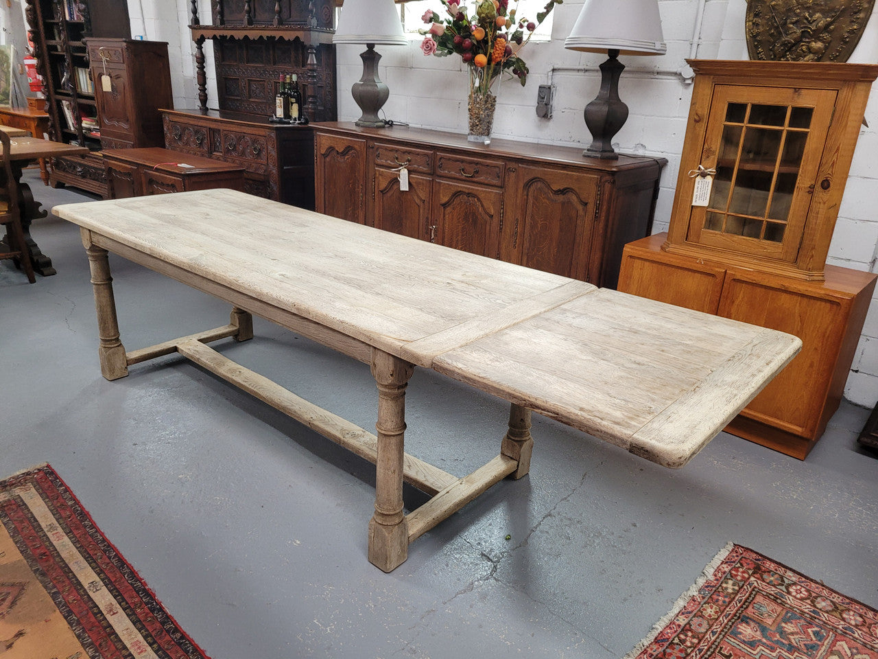 Beautilful raw solid oak French pedestal extension table. It has been sourced from France and is in good original detailed condition. When the table is fully extended it is 339 cm long and can comfortable seat 10-12 people. Features raw wood that could be used as is for a distressed look, or finished and waxed for a more refined look.