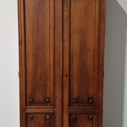 French Henry II style Walnut linen storage cupboard with nine pull out shelves. This piece could be very functional for a range of different purposes including shoe storage. It is in good original detailed condition, please note the door lock no longer functions and opens by pulling the door.