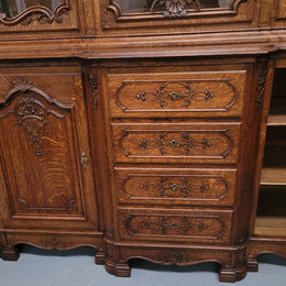 Impressive French Oak Louis 14th Style Display and Sideboard. It has 4 drawers, 2 bottom cupboards with 6 total shelves and 3 display doors with 3 shelves.  In good, detailed condition.