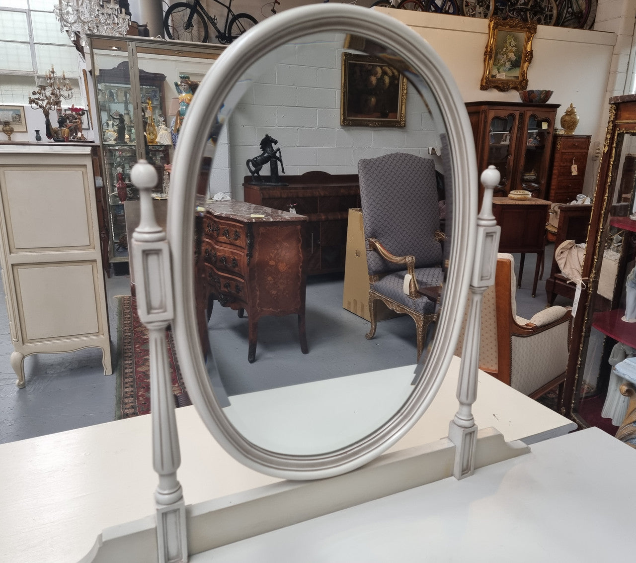 French Louis XVI style painted dresser / console with beveled oval mirror and three drawers. Sourced from France and in good original detailed condition.